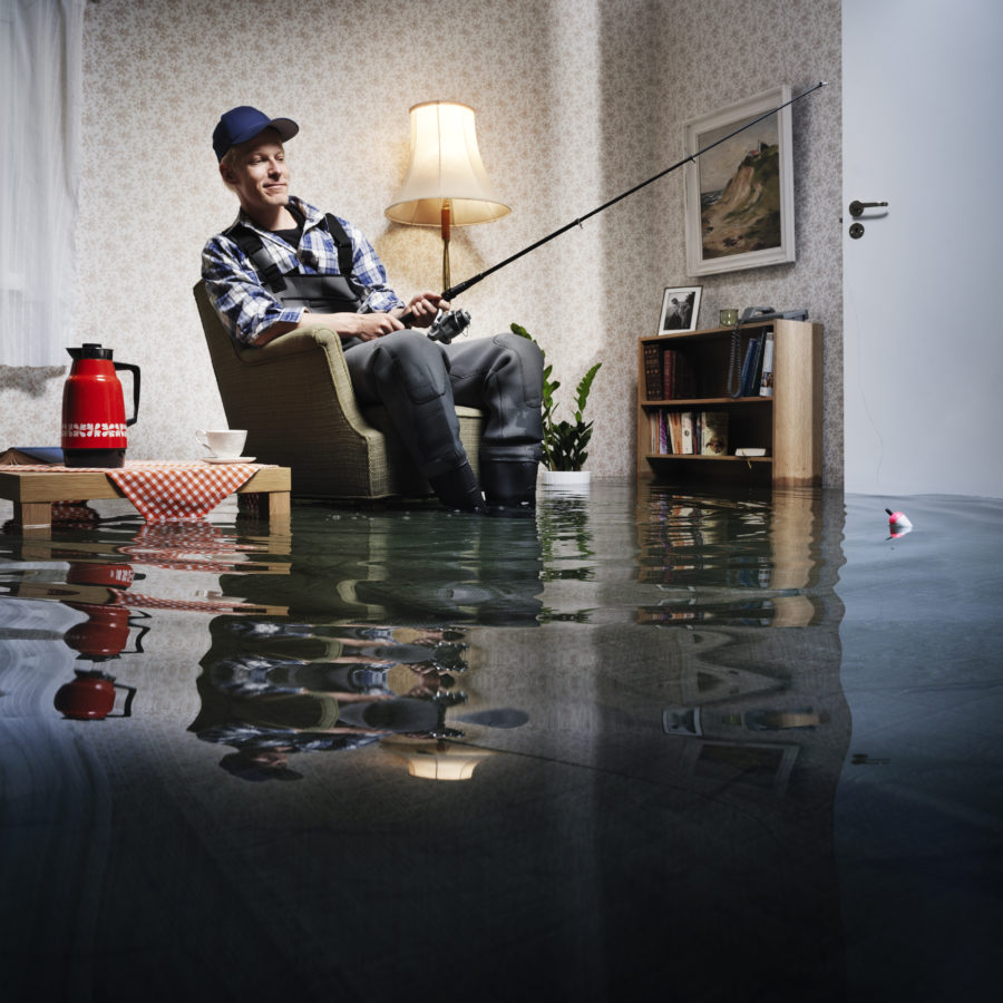 young man fishing in flooded room
